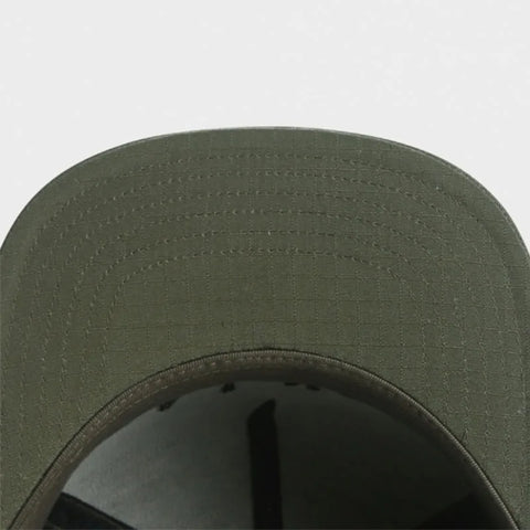 Close-up of a green cap on a light gray background