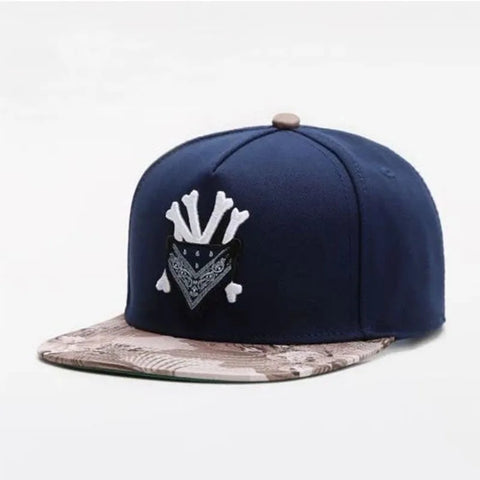 Navy blue cap with white logo and camouflage brim on a light gray background