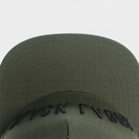 Green cap with embroidered 'BLACK LABEL' text on a light gray background