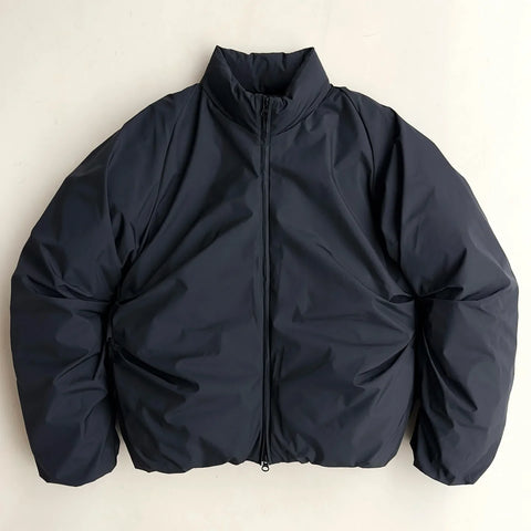Dark blue jacket on a light beige background