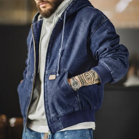 Man wearing a blue denim jacket with a blurred background